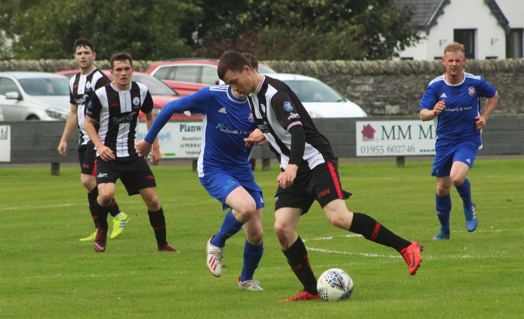 Ryan Campbell holds off a challenge in midfield during Academy’s 5-1 win against Lossie.
