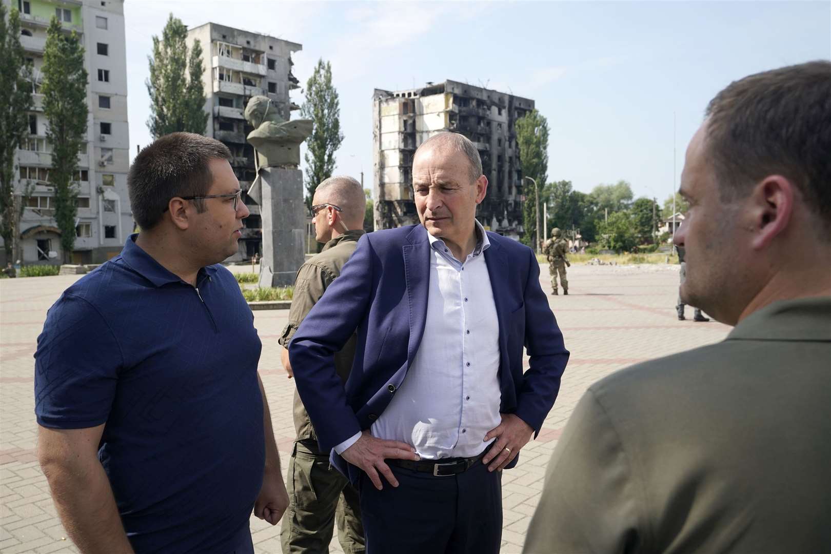 Micheal Martin with local officials viewing the damage to the Borodyanka area of Kyiv (Niall Carson/PA)