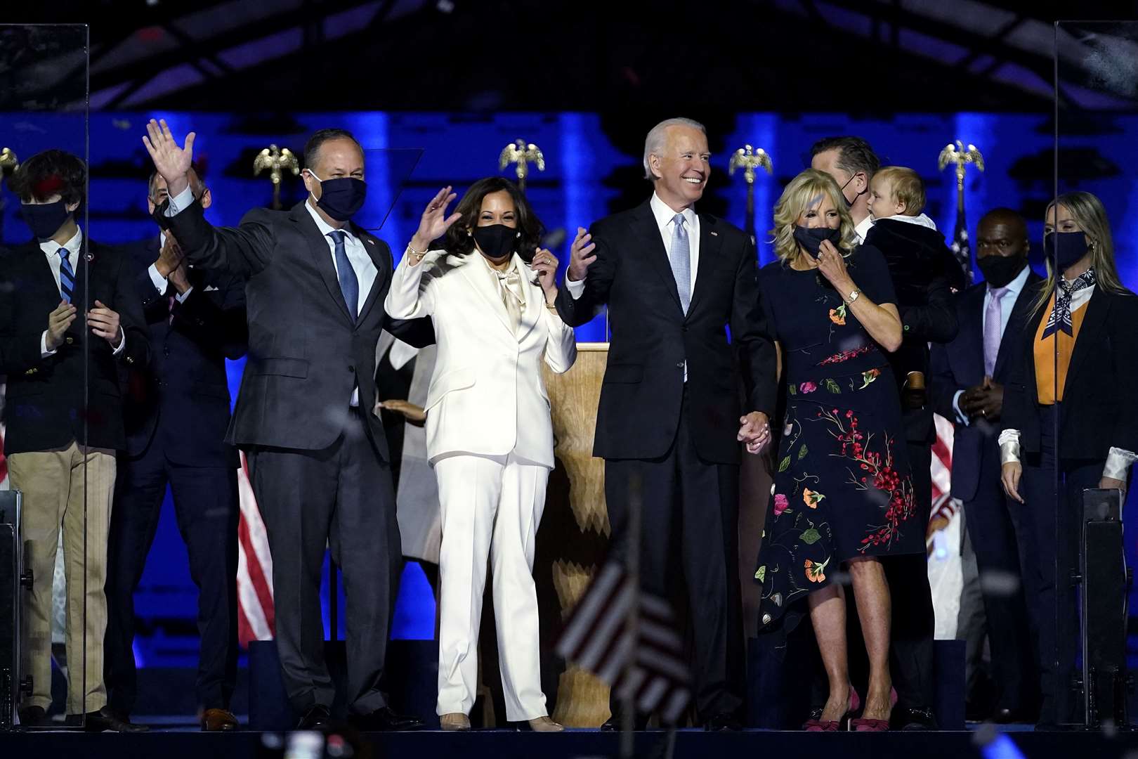Doug Emhoff, husband of Vice President-elect Kamala Harris, Ms Harris, President-elect Joe Biden and Jill Biden stand on stage together (Andrew Harnik/AP)