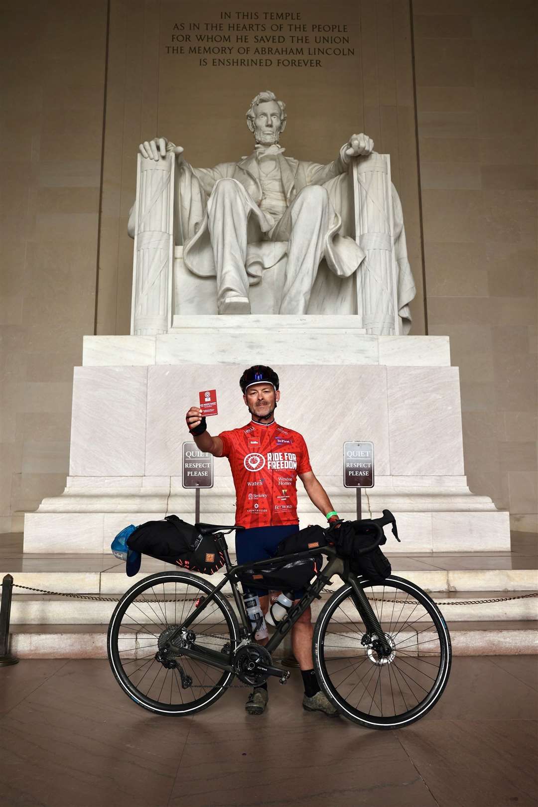Gordon Miller at the Lincoln Memorial in Washington DC, USA, showing the red card to modern slavery and human trafficking in sport (James Aubry/Humble Hedgehog Productions)