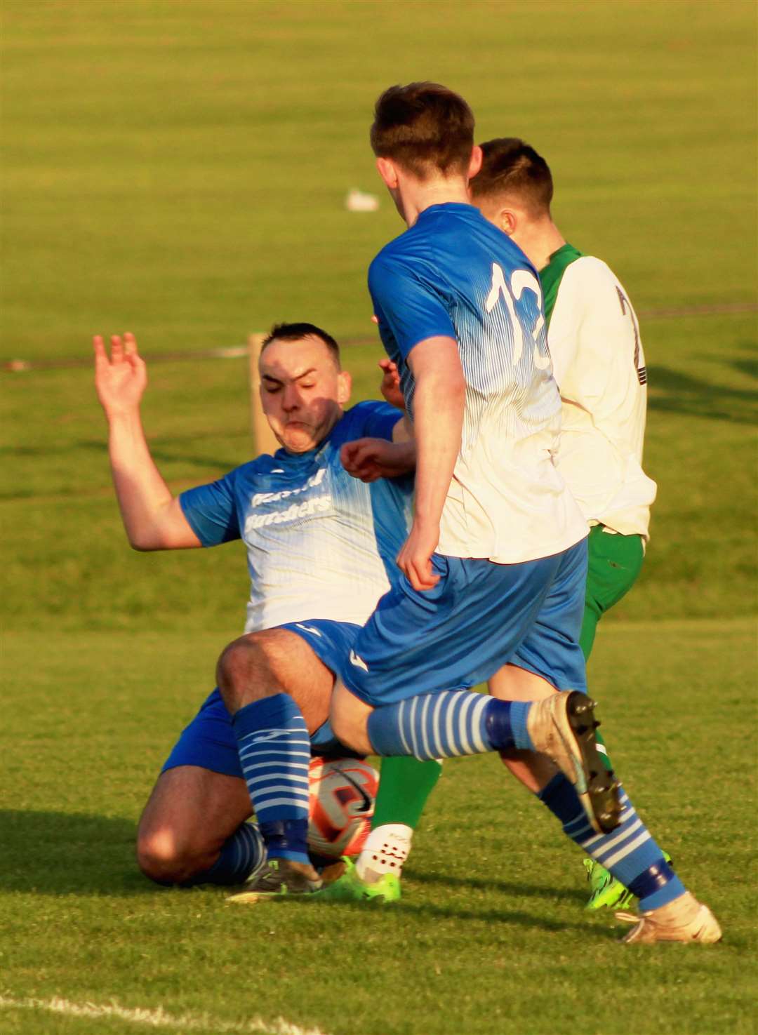 Wick Thistle player/manager Owen Harrold puts in a tackle against Castletown.
