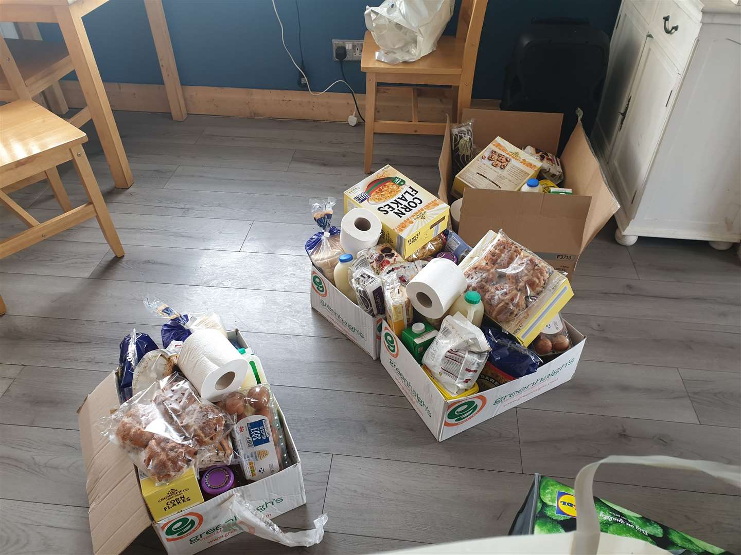 Boxes of food that have been prepared by the volunteers at the café to be delivered to local people in need.