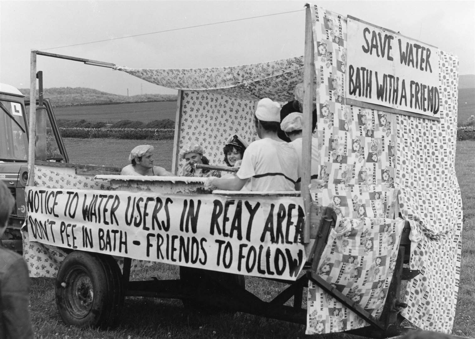 Bath-time fun on a gala float making some topical comments about water Reay water supplies. Jack Selby Collection / Thurso Heritage Society