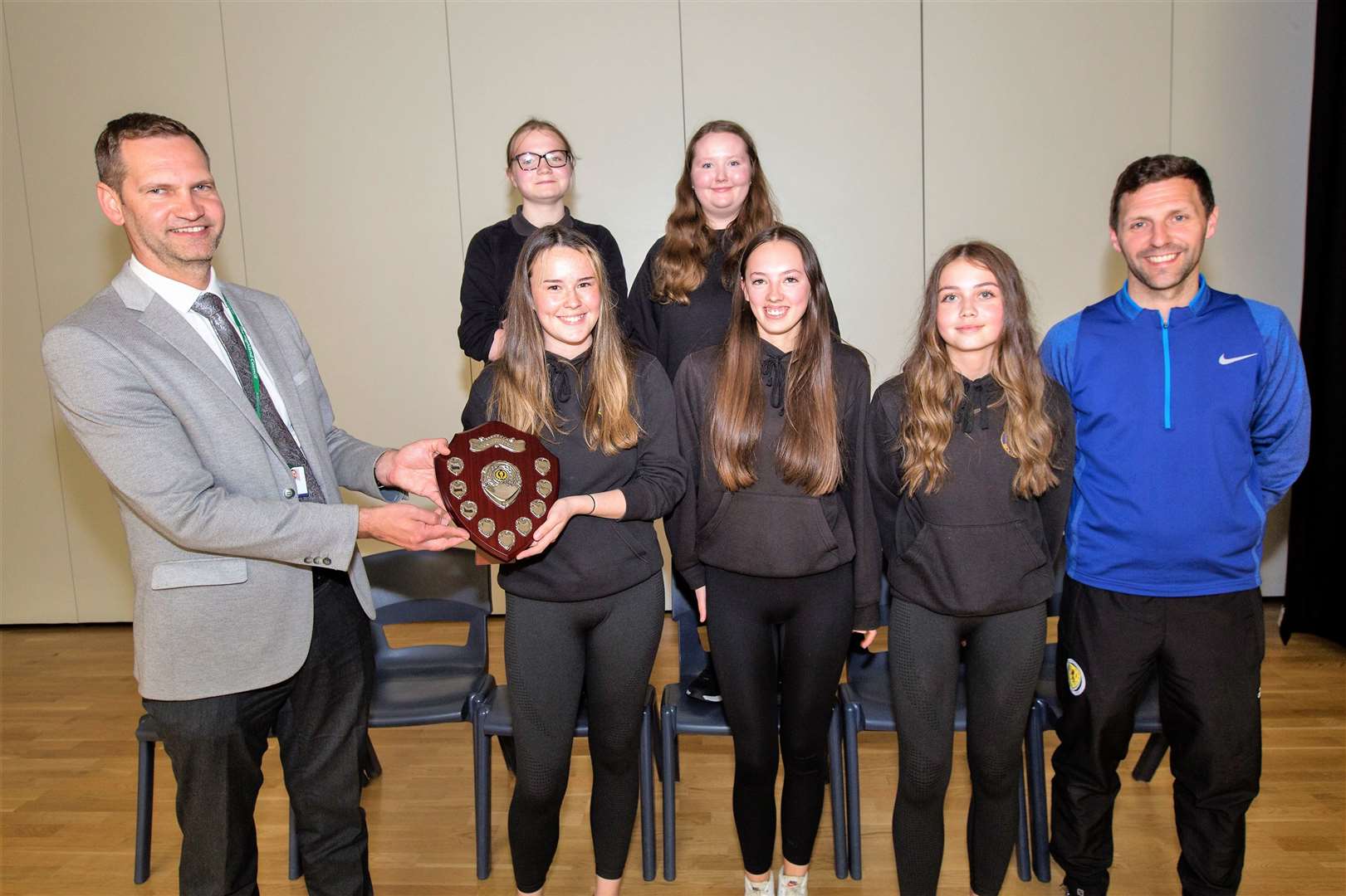 Wick High School's house sports trophy was won by Noss. Rector Sebastian Sandecki is seen here presenting the trophy to house representatives, from left, (front), Katie MacDonald, Lucy Harper, Abby Swanson, (back), Blyth Bullen and Erin Moore. Looking on is Alan Davis, head of faculty. Photo: Robert MacDonald/Northern Studios