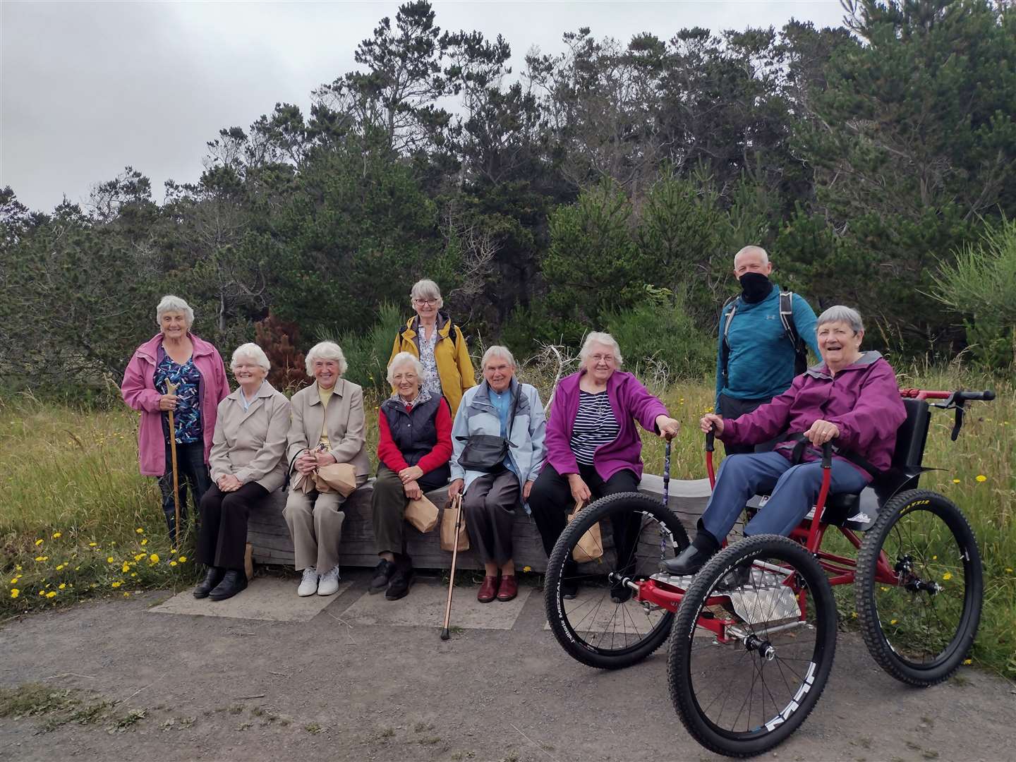 Ann Penman gives the wheelchair a try at Dunnet Forest, with others from Dunbeath & District Centre looking on along with George Ewing.