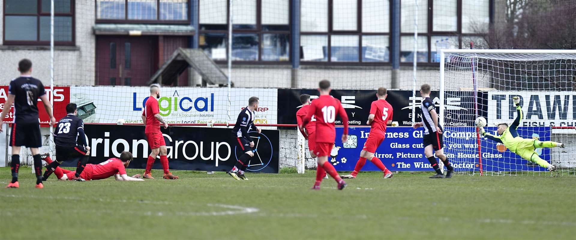 Academy's Sam Mackay watches as his shot flies past Brora keeper Joe Malin to make it 2-1. Picture: Mel Roger