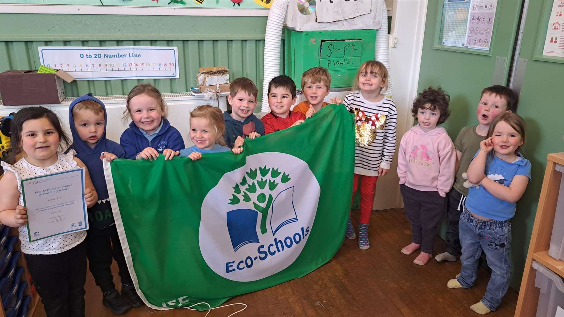 Children from Watten ELC celebrate with their third Eco-Schools green flag.