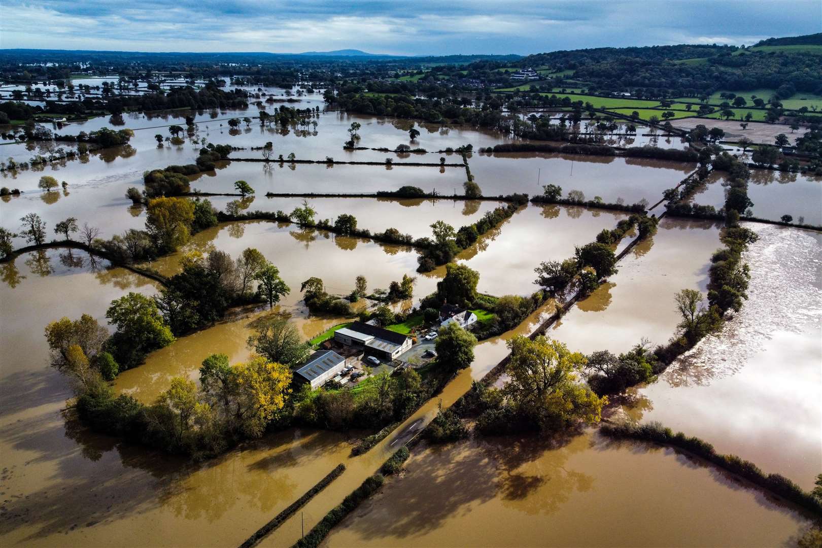 Flooded fields in Powys in Wales (Ben Birchall/PA)