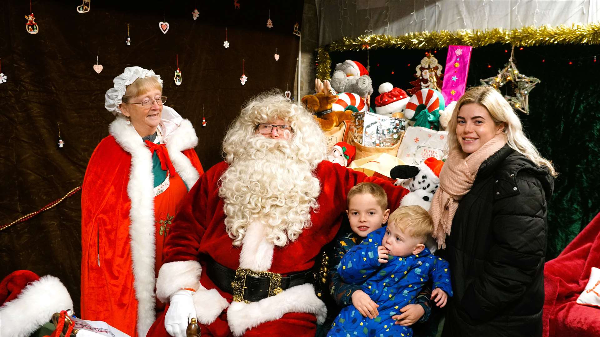 Jessica Hooker with her children Richie and Brogan meet Santa and Mrs Claus at their grotto in the back of Highland Hospice charity shop in Thurso. Picture: DGS