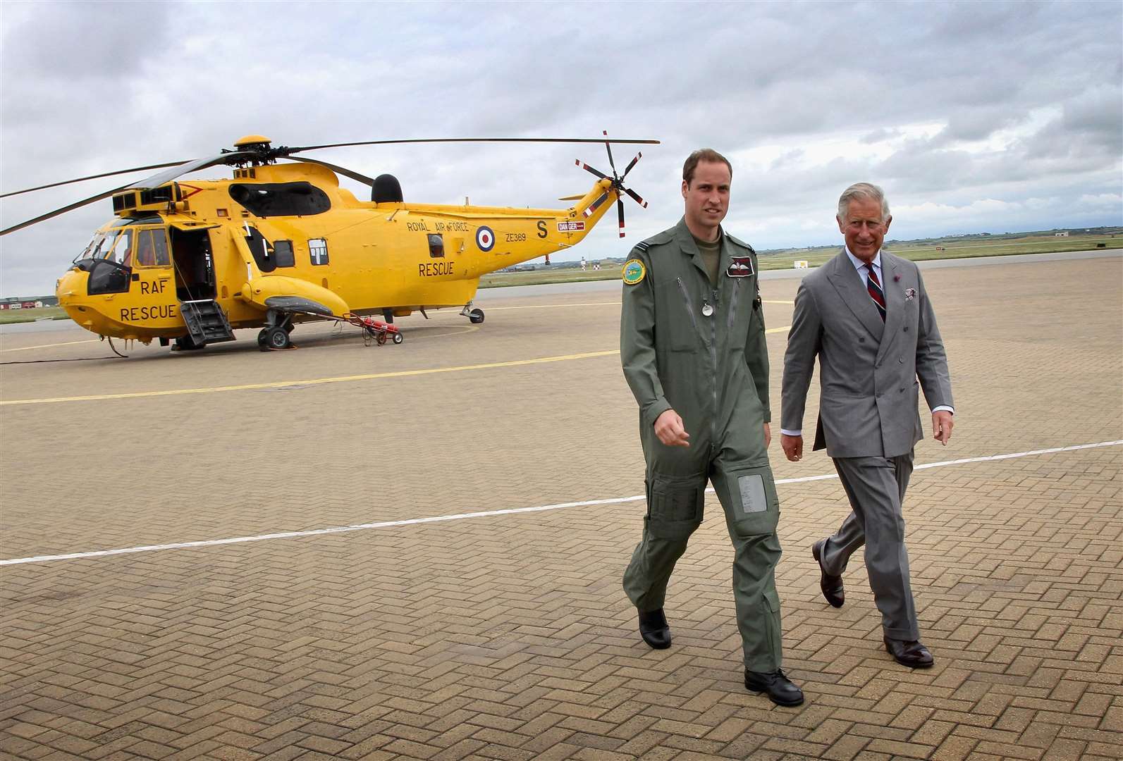 William showed his father one of the Sea King helicopters he captained at RAF Valley on Anglesey in 2012 (Chris Jackson/PA)