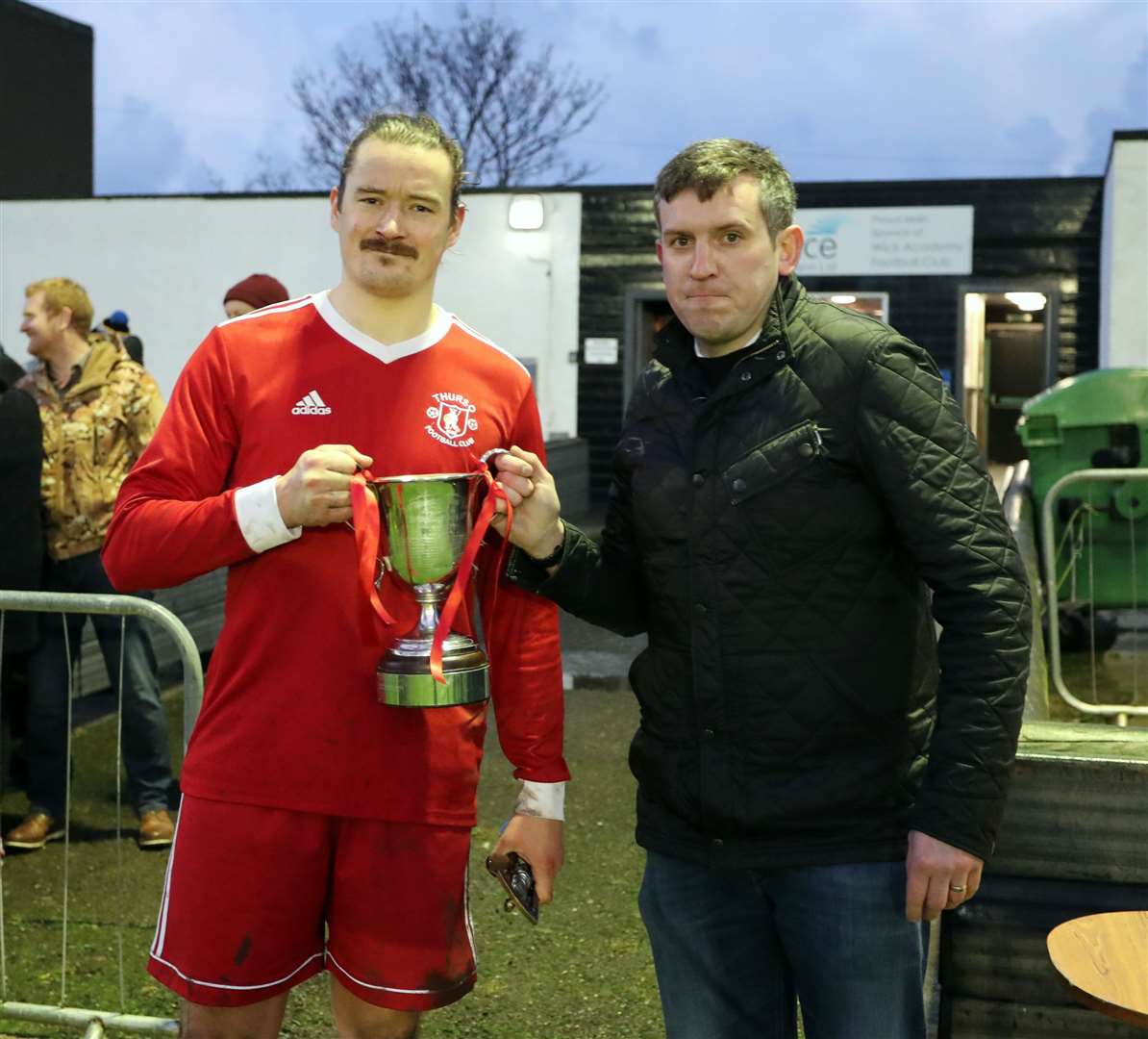 Thurso captain James McLean receives the Football Times Cup from North Caledonian League secretary Sandy Stephen. Picture: James Gunn