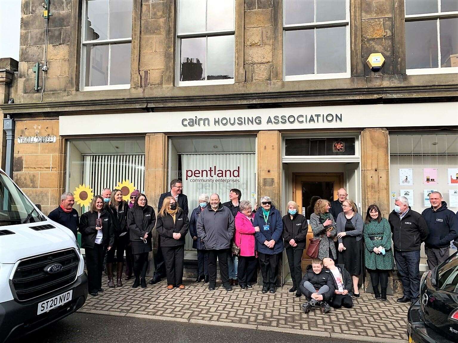 Group picture outside the Cairn Housing Association office in Thurso for the official opening event.