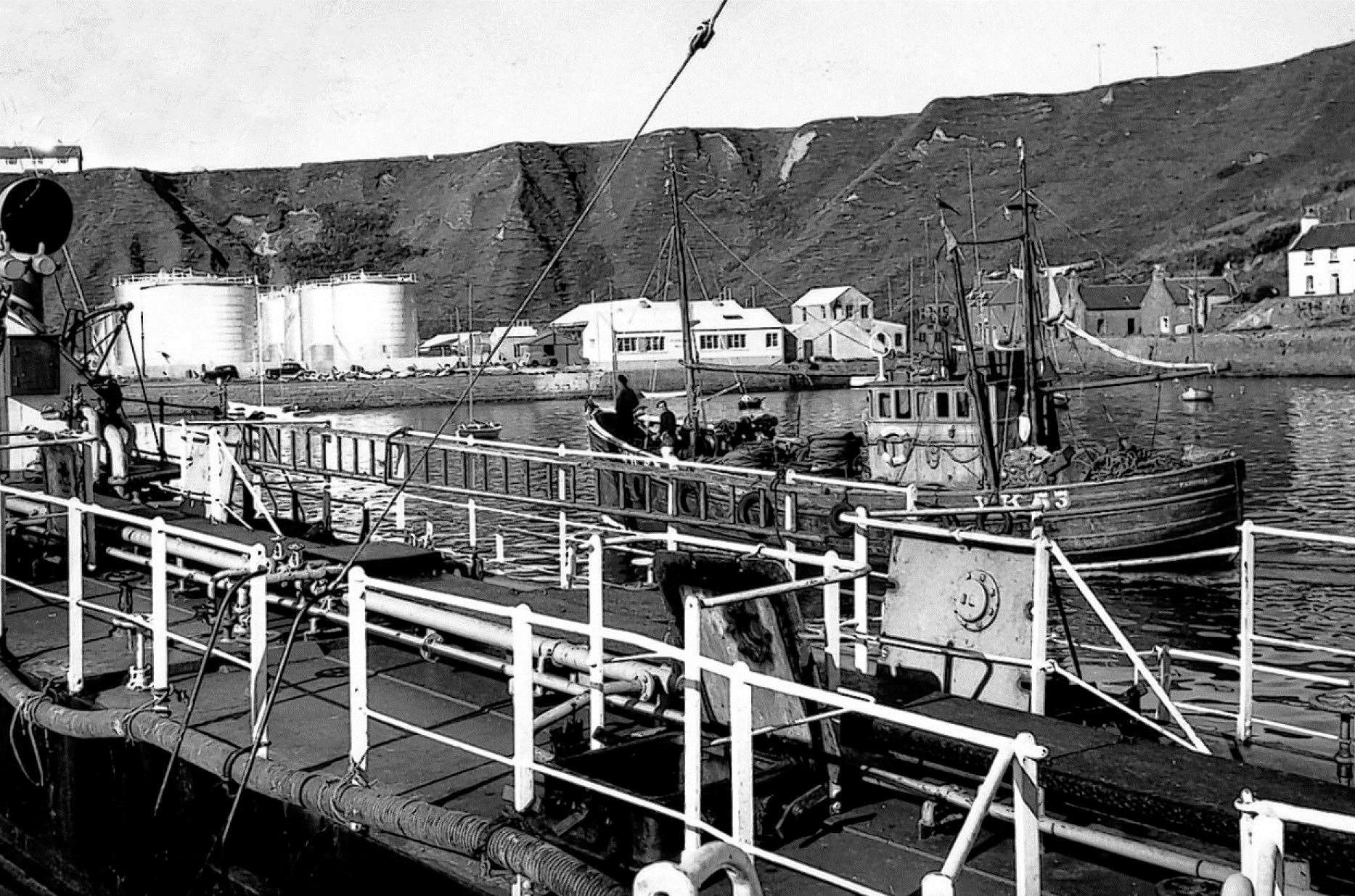 There have been many changes and improvements to port facilities at Scrabster since this picture was taken. The fishing boat entering the harbour is thought to be the Wick-registered Pavonia.