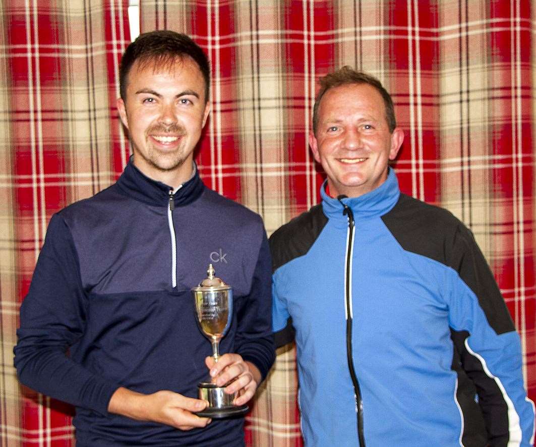 Gregor Munro (left), the gents' Reay scratch club championship winner, accepts his trophy from Andy Bain, the club captain.