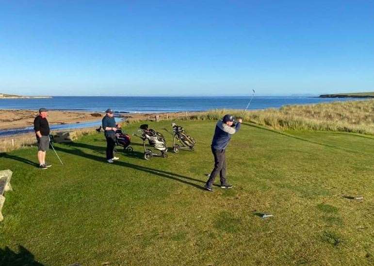 Andrew Taylor teeing off at Reay's fifth hole as Steve Efemey and Lee Parnell look on.