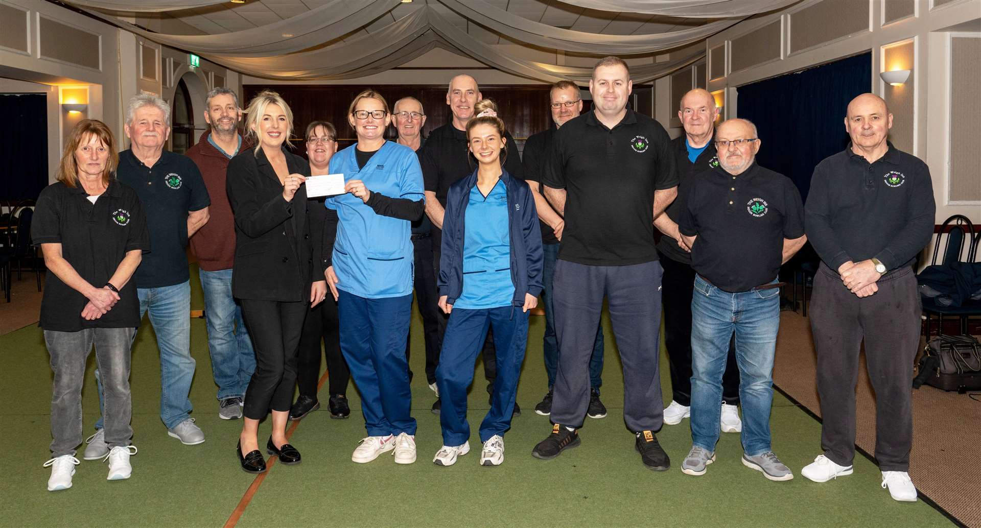Donna Swanson (Weigh Inn) presenting the cheque to Claire Mackay and Ebonnie Bremner (west Caithness district nurses). Club members looking on are Sandra McCulloch, Ali Gray, Gordon Nicoll, Leah Taylor, Trevor Henderson, Iain Elder, Allan Sutherland, John Gill, Bob Bell, Davie Alexander and Colin Floydd. Picture: Billy Husband