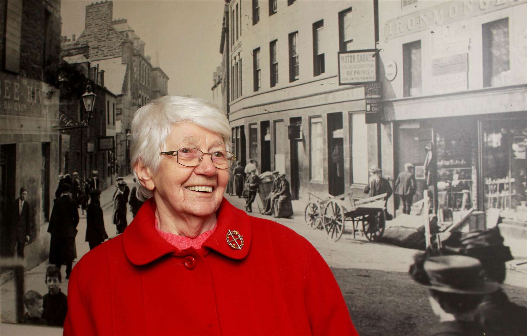 Lily MacGregor (92) in front of a Johnston enlargement of Wick town centre. Picture: Alan Hendry