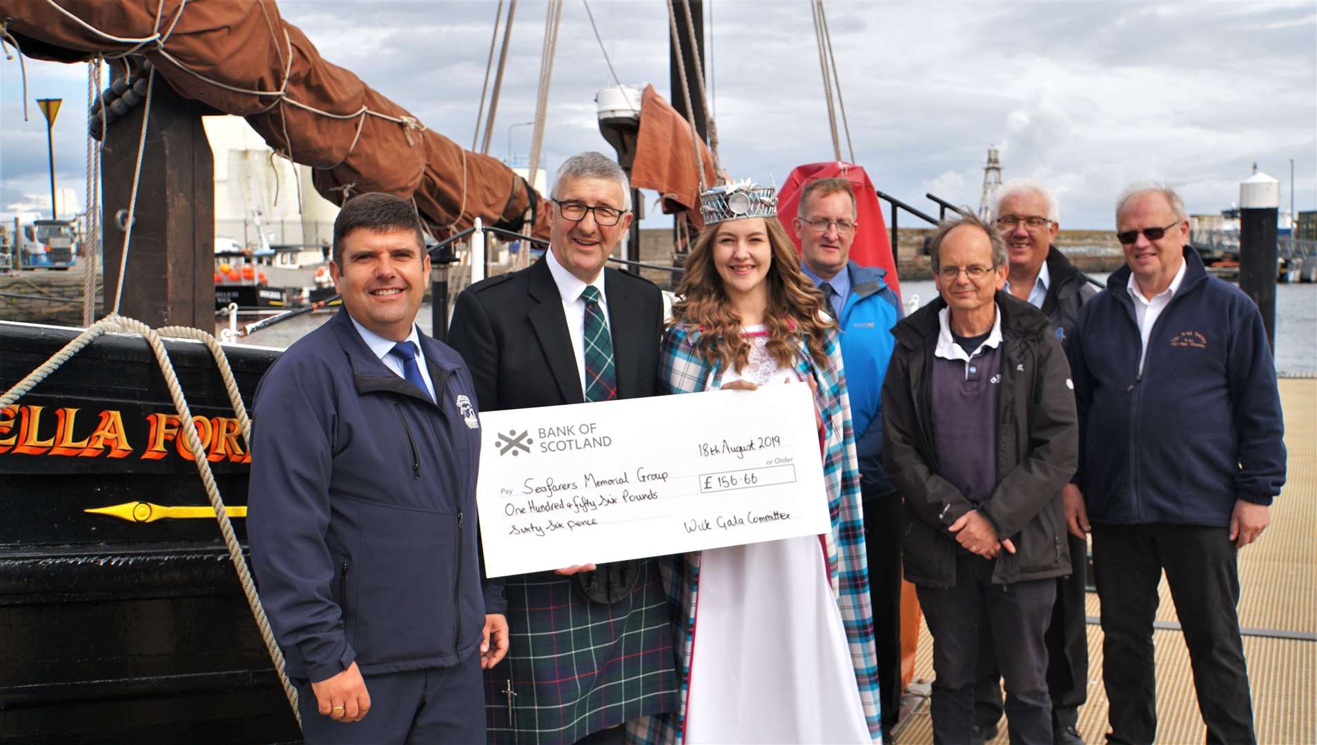 Wick gala queen Maja Pearson hands over a donation from the Wick Gala Committee of over £150 to Willie Watt for the Seafarers Memorial Group. Money raised by the group will go towards the creation of a permanent sculpture. Picture: David G Scott
