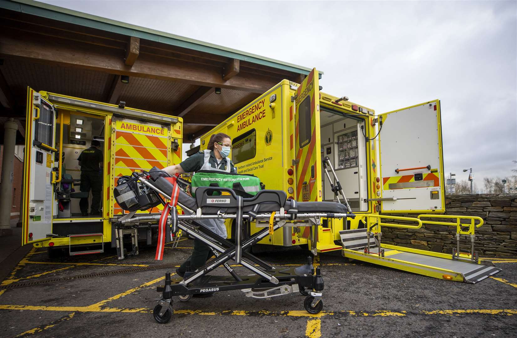 Ruth Corscadden returns to her ambulance as several crews with patients wait outside the Causeway Hospital (Liam McBurney/PA)