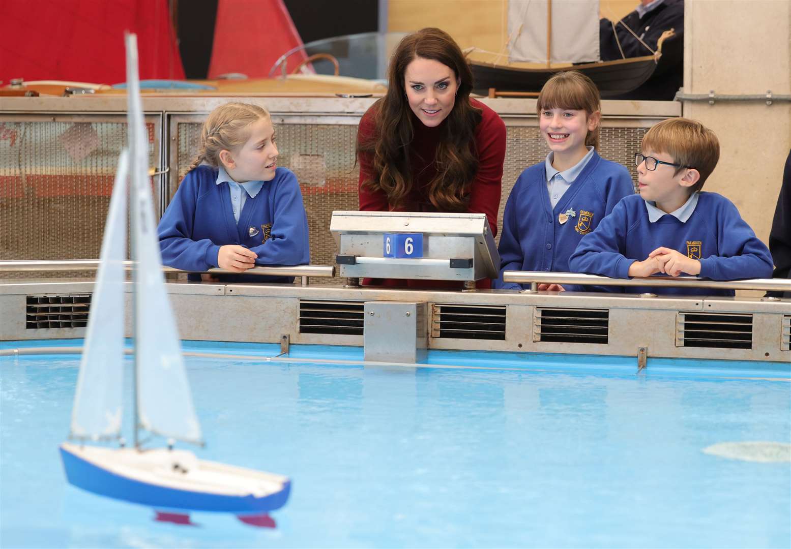 The Duchess of Cornwall and schoolchildren take part in a model boat race (Chris Jackson/PA)