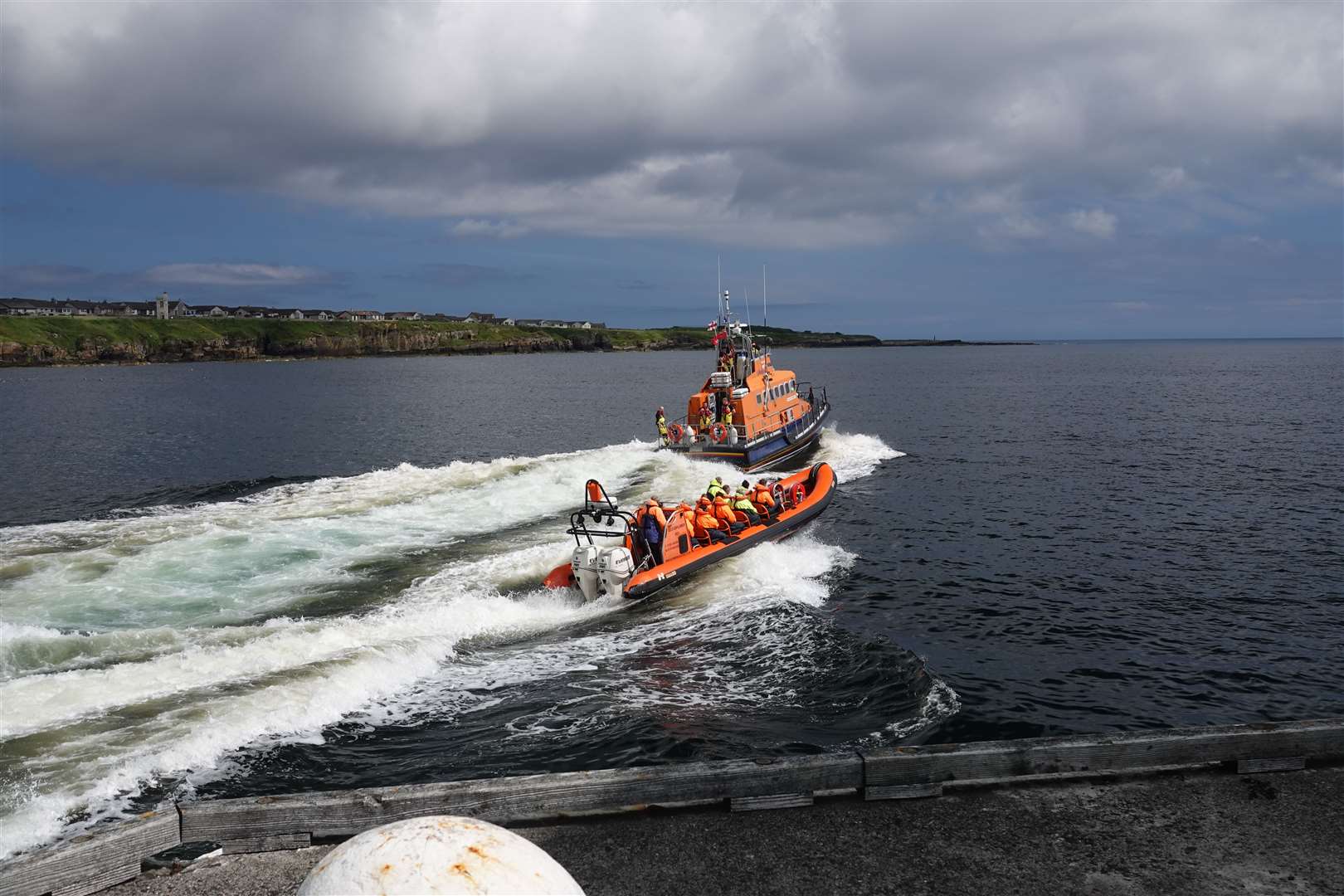 Derek Bremner sent this image of the Wick lifeboat Roy Barker II and Caithness Seacoast's Geo Explorer leaving Wick harbour recently.