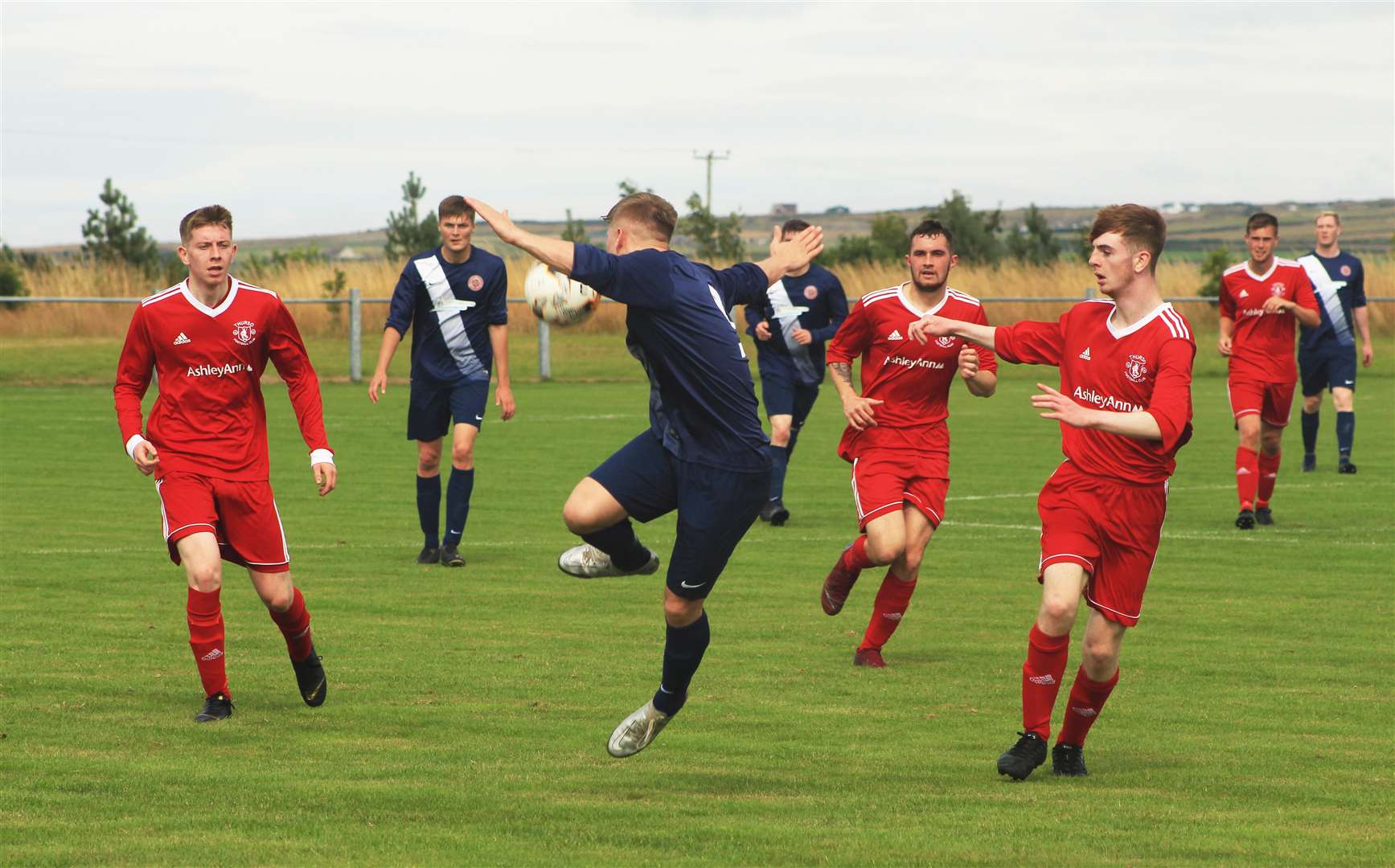 Halkirk United's Korbyn Cameron receives the ball while surrounded by Thurso players during Saturday's derby at Morrison Park.