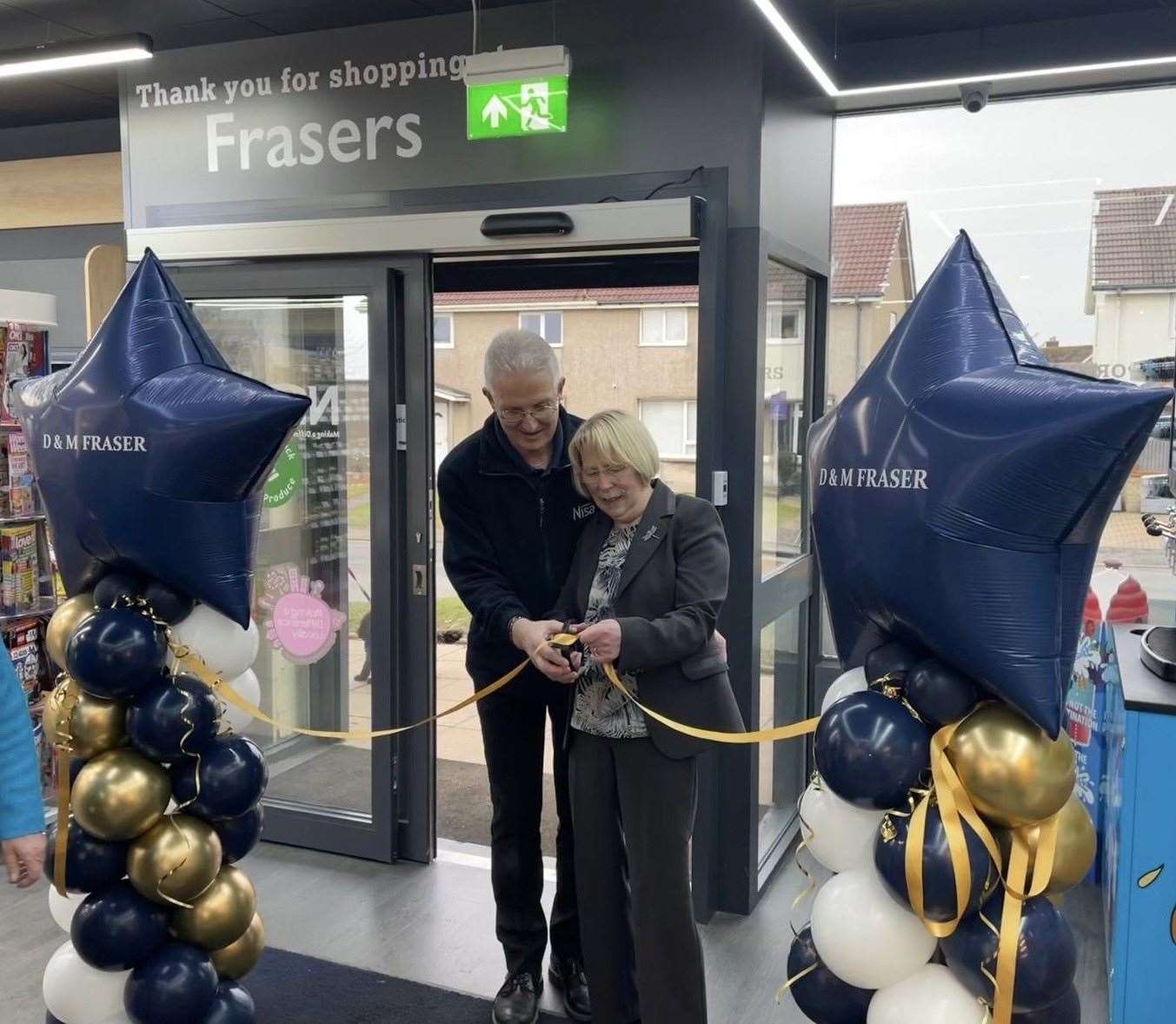 Scott and Marigold cutting the ribbon at the grand opening.