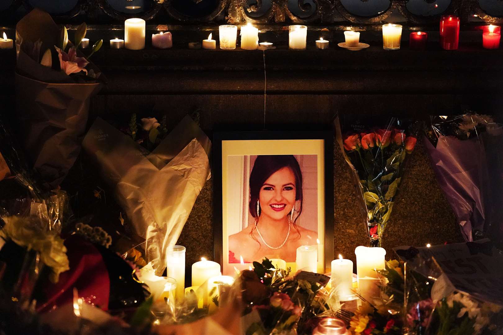 A photograph of Ashling Murphy among flowers and candles during a vigil in her memory in Dublin (Brian Lawless/PA)