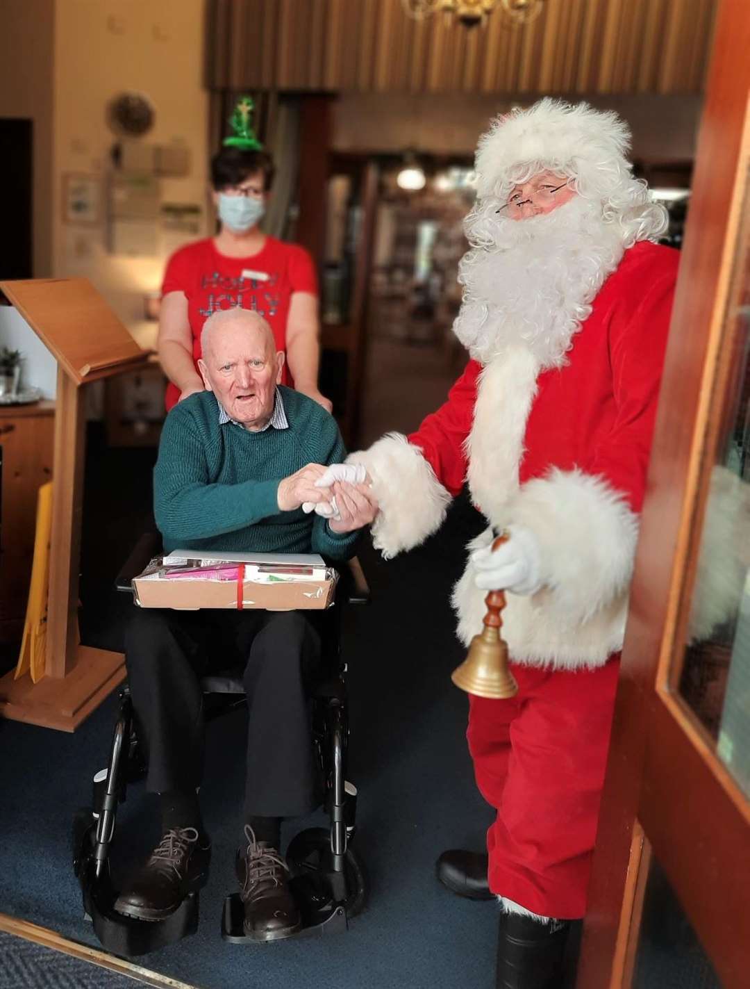 Seaview House care home resident David Alexander is presented with a Christmas hamper from the Fishermen’s Mission by Councillor Willie Mackay dressed as Santa.