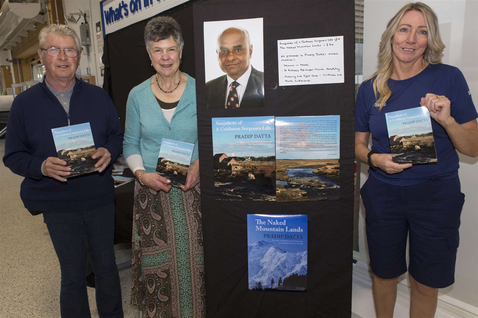 Dr Loretta Davis-Reynolds and Roy Mackenzie holding copies of Snapshots of a Caithness Surgeon's Life alongside Tesco Wick community champion Karen Center at Friday's book-signing. Picture: Robert MacDonald / Northern Studios