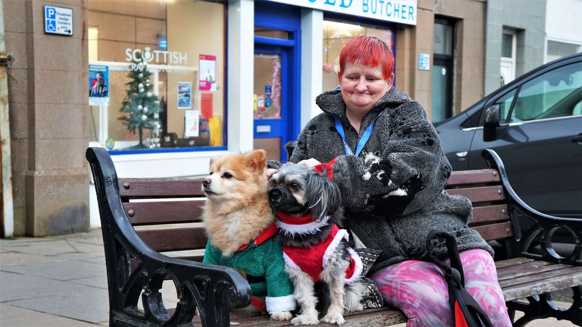 Linda Fraser with her dogs Ralphie (left) and Rocky who were dressed in Christmas costumes. The two dogs are well-known in the town centre. Picture: DGS