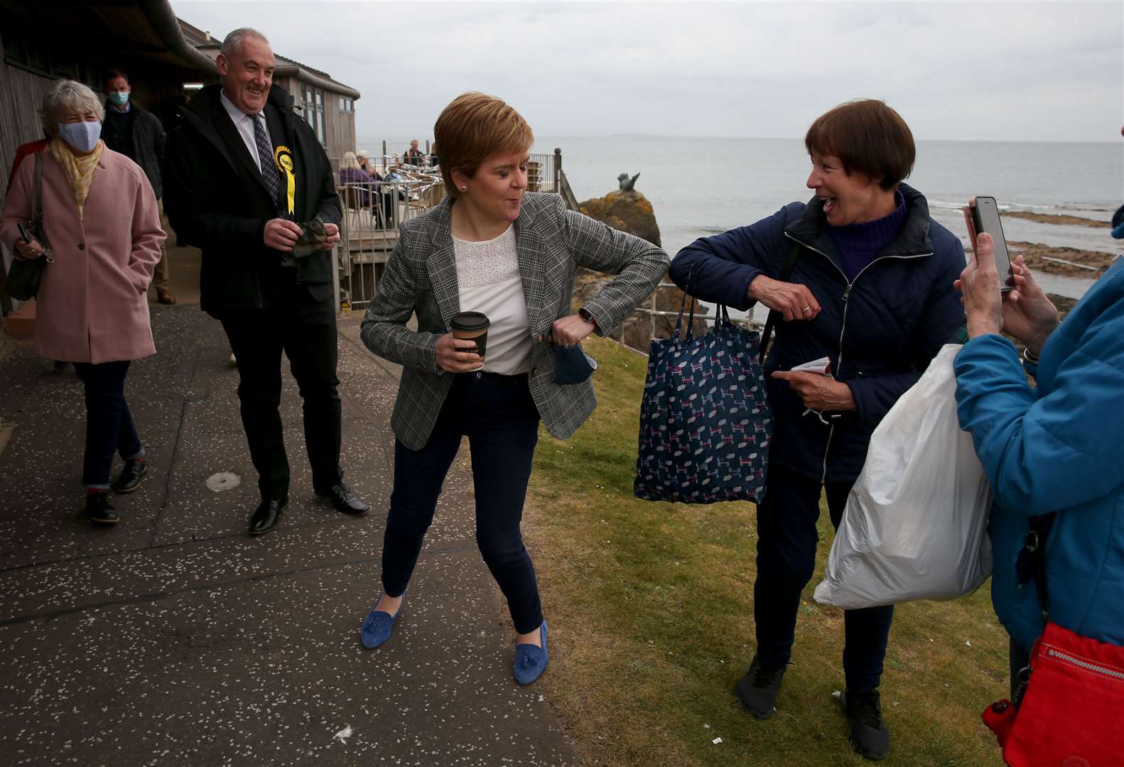 Nicola Sturgeon greets a supporter with an elbow bump on the campaign trail in North Berwick (Andrew Milligan/PA)