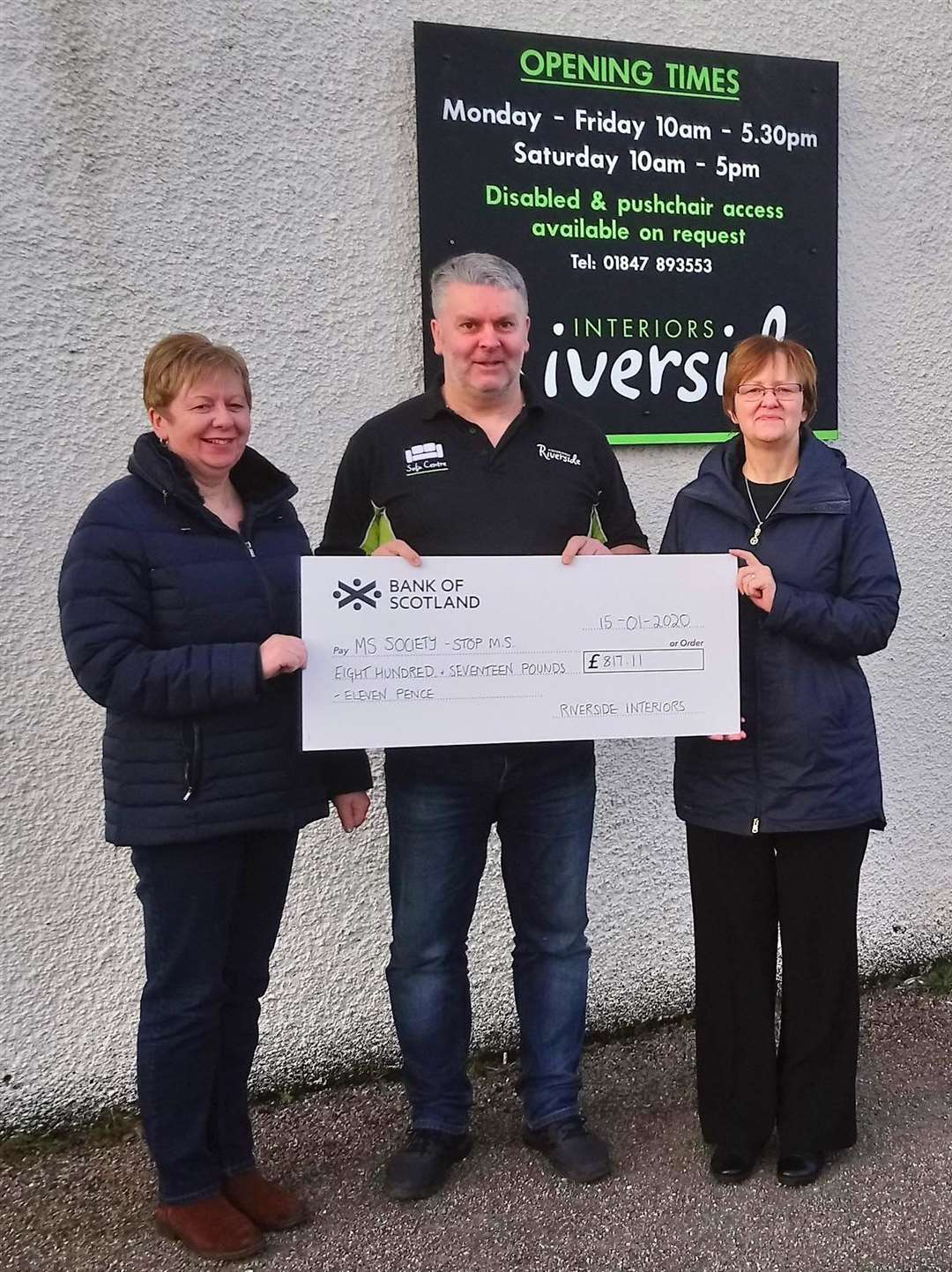 Receiving the cheque from Carl Swanson, proprietor of Riverside Interiors, are MS Society Caithness Group volunteers Sandra Macdonald (left) and Catherine Cowan.