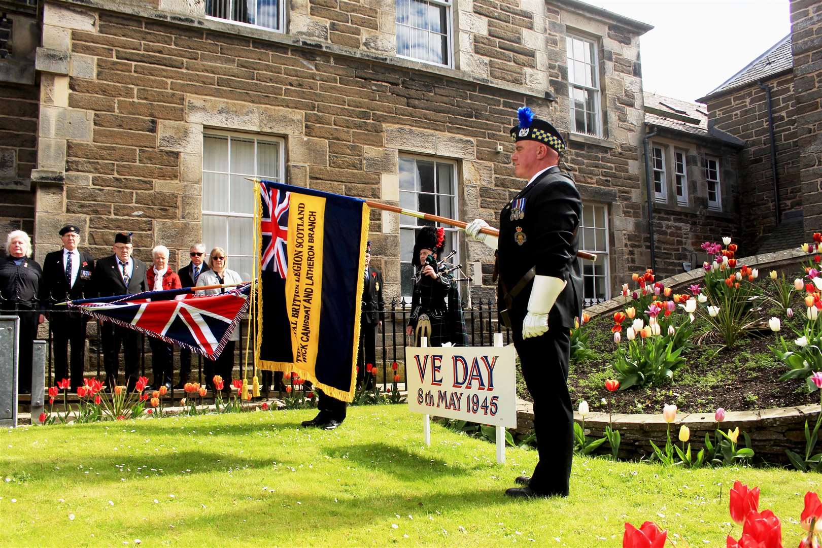 The VE Day commemoration in progress, with Legion standard-bearer Kevin Stewart on the right. Picture: Alan Hendry