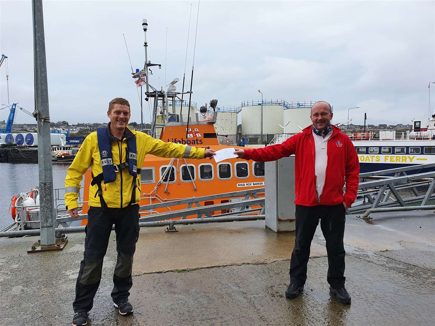 Billy Cowie, of C Food & Eat, presents a cheque to Allan Lipp, coxswain of the Wick lifeboat.
