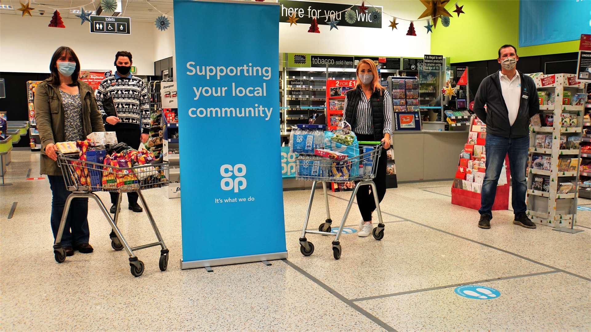 Pictured with the trolleys of donated food are from left, Treasa Hamilton, secretary of Keiss Primary School's parent council; Wick Coop manager Modris Karklins; Claire Clark from Caithness Community Connections based in Lybster; and the supermarket's member pioneer Jamie Robson. Picture: DGS