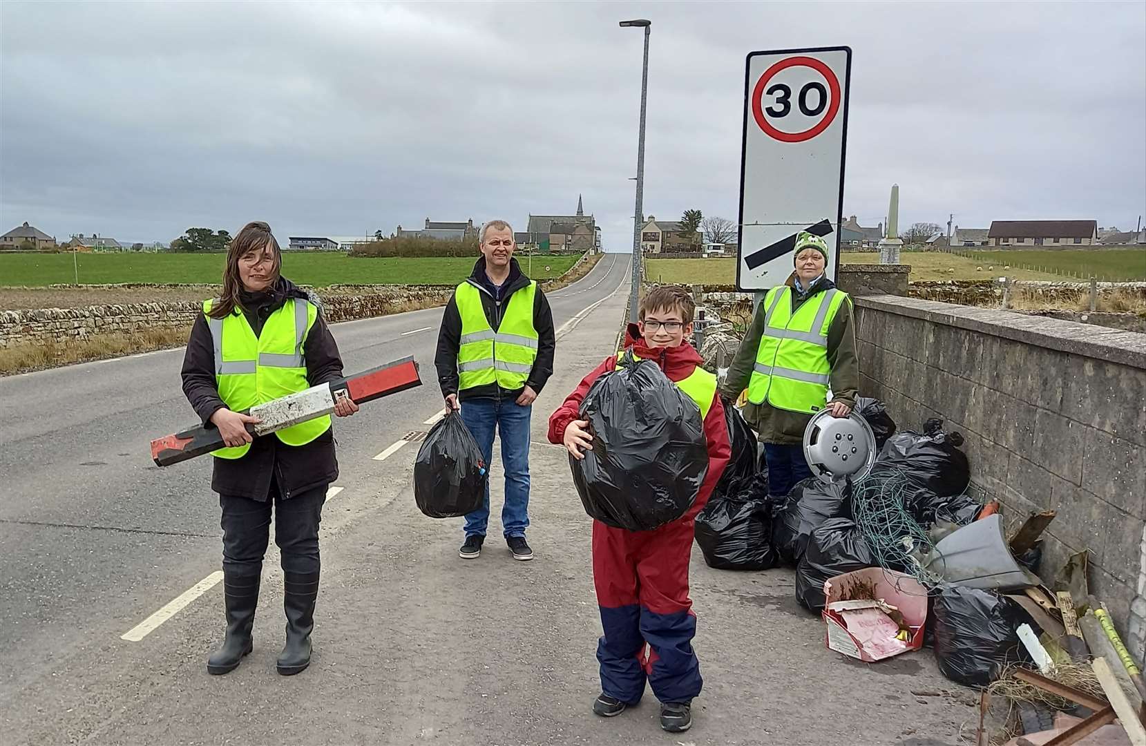 Treasa Hamilton, holding a smashed flexible bollard, alongside Stevie Tait, Treasa's son Thomas and Carol Tait after their latest litter-collecting session. Picture: Willie Mackay
