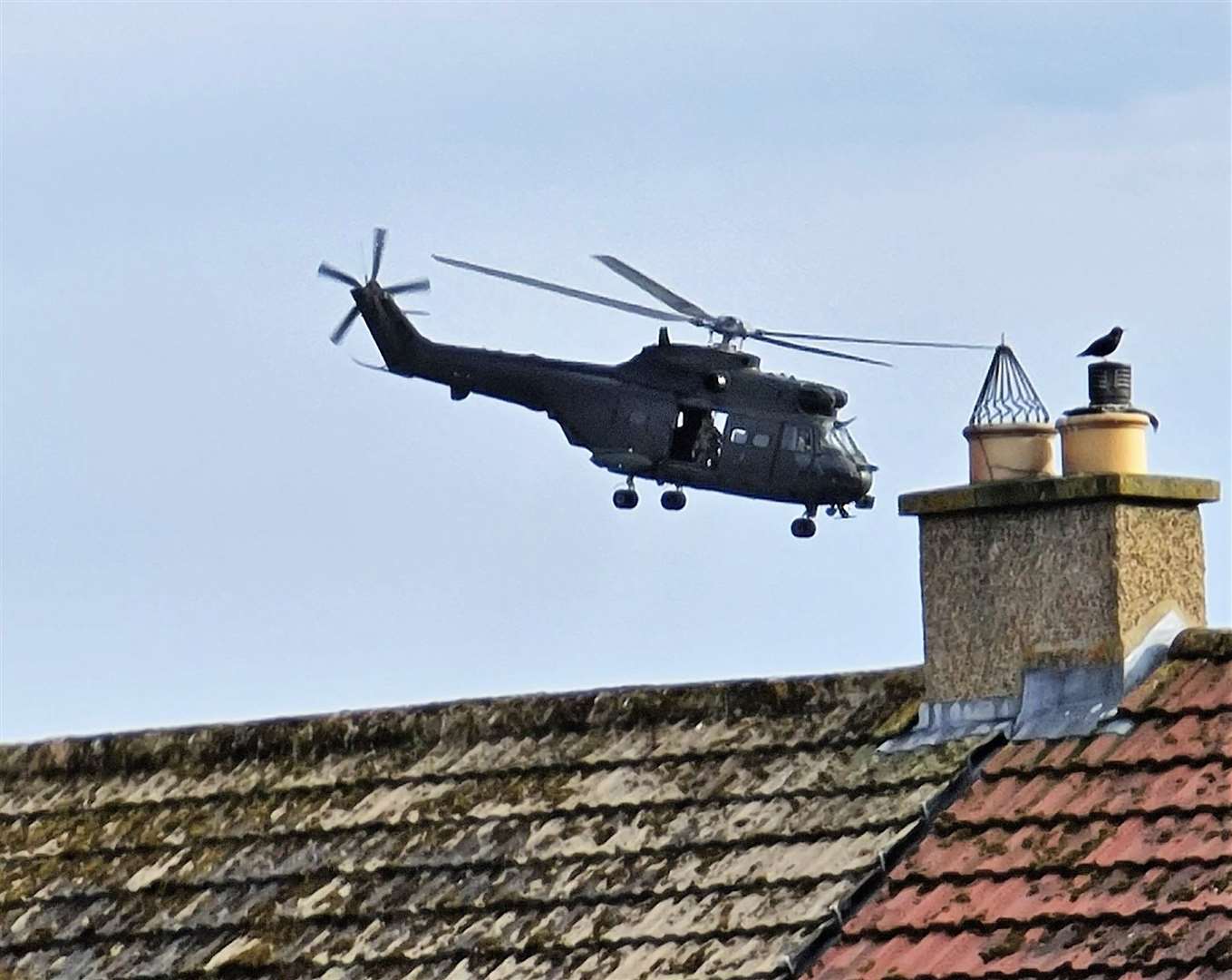 A helicopter hovering over rooftops near Thurso High School shortly after 5pm on Tuesday. Picture: Kerrie Gillies