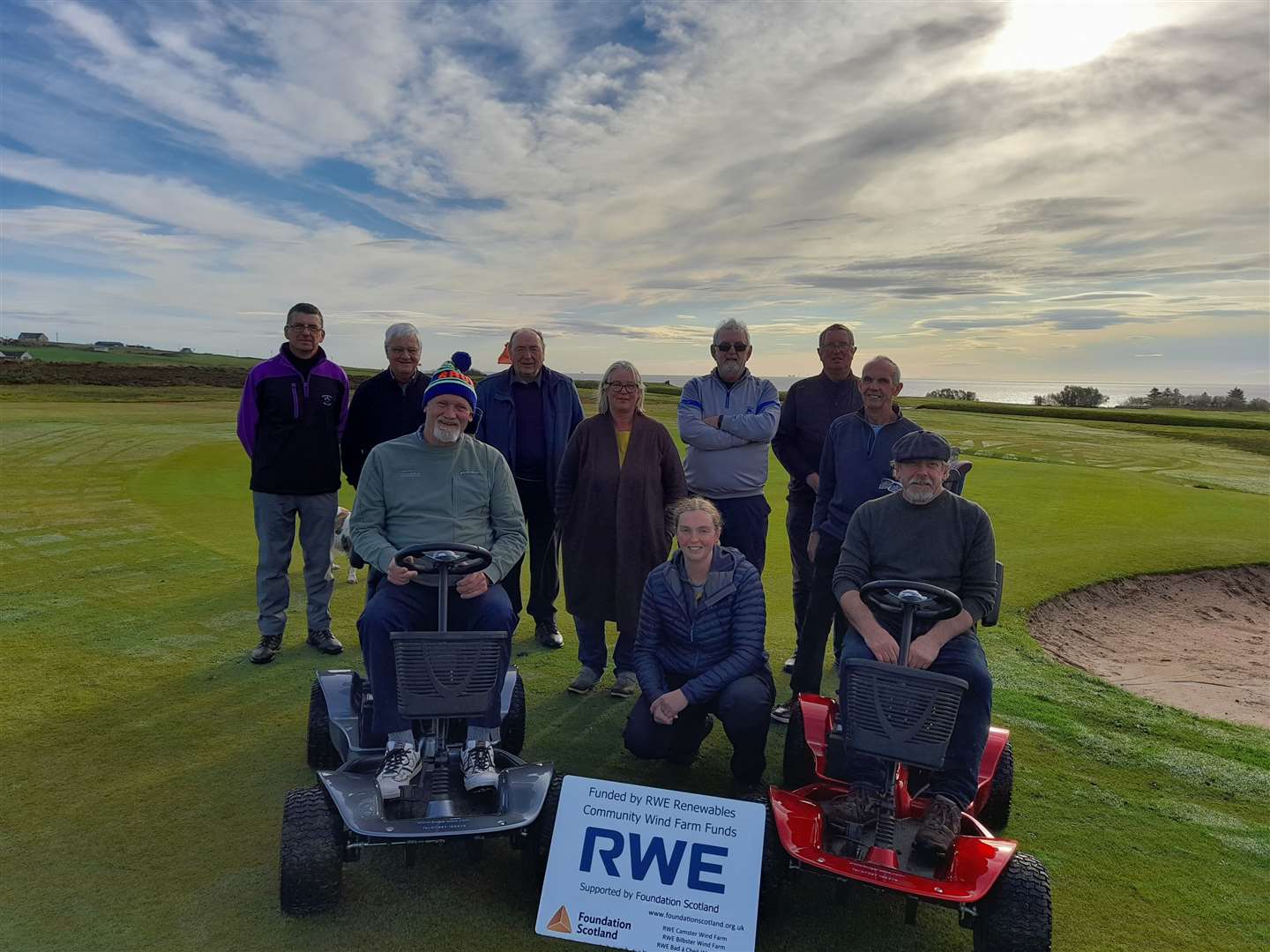 Eilidh Coll of Foundation Scotland (front, centre) with Dave Wilson (left) and Malcolm Sutherland on the new buggies along with members of Lybster Golf Club.