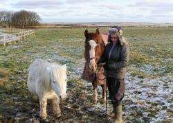 Jane Paige with her horse, Buddy, who survived his ordeal and Shetland pony Sunny who was not affected.