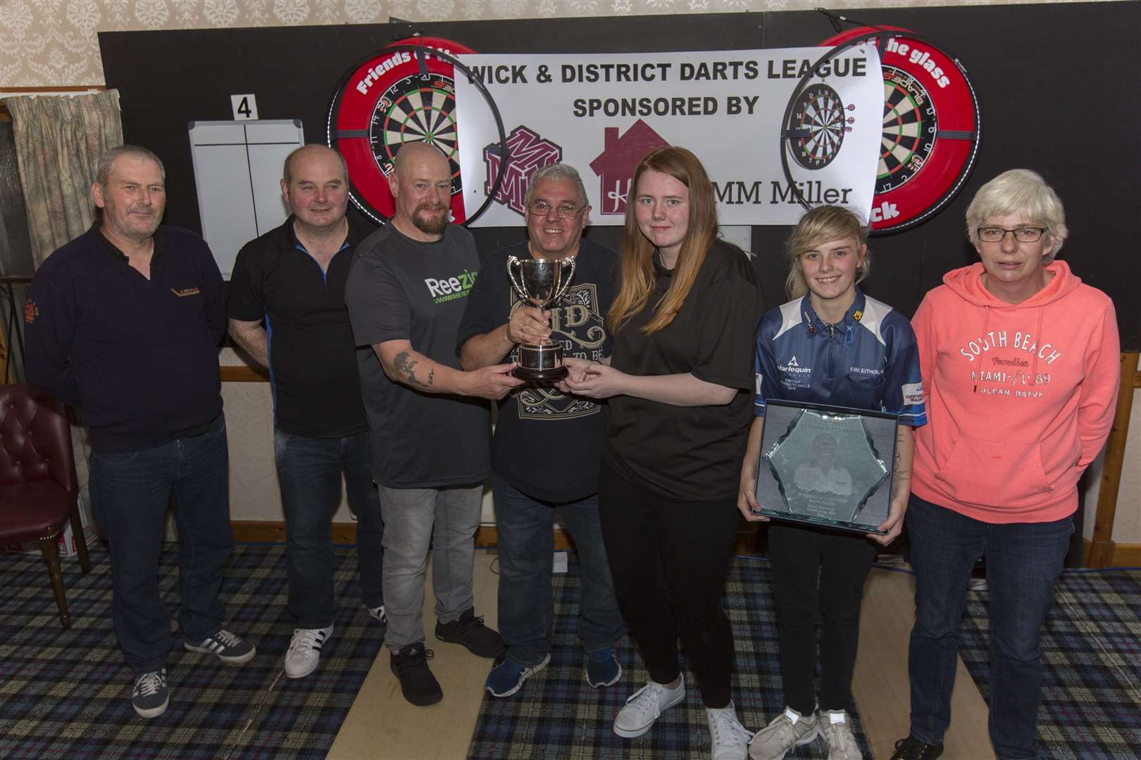 Wick and District Darts League's Colin Perry Memorial Cup for men's pairs is presented by his daughter, Morgan, to Jocky Plowman (centre) and Kevin Donald, Queen's 2. Runners-up were David Taylor (left) and Alan Nicolson, Harper's B. The Alice Coghill Memorial Trophy for ladies' singles was won by Kara Sutherland, with Freda Perry runner-up, both Queen's. The competitions were played on Tuesday in the Seaforth Highlanders' Club. Picture: Robert MacDonald / Northern Studios