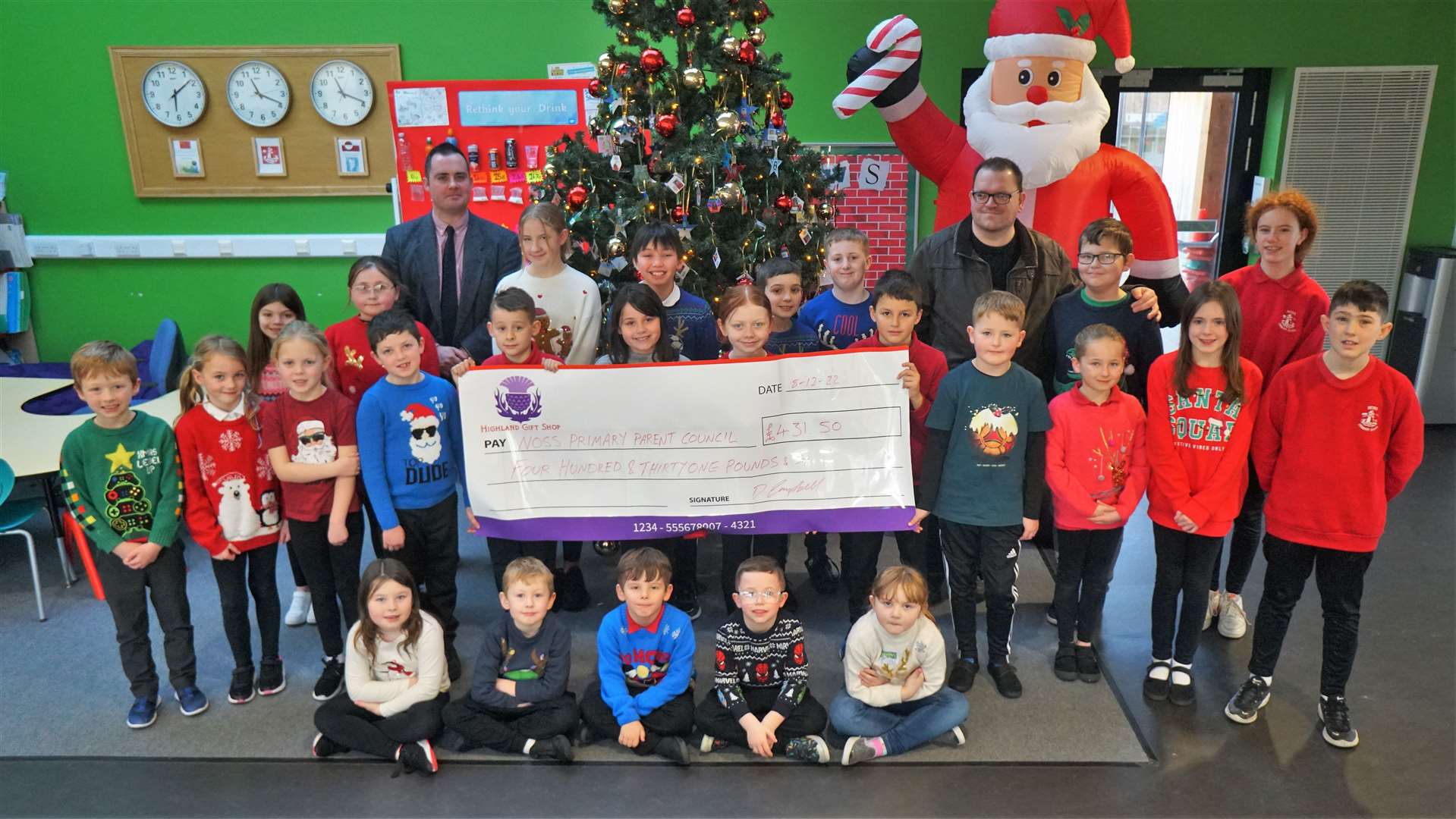 Children from Noss Primary School Pupils' Council with a cheque for £431.50 that was raised from the sale of Christmas card designs. Picture: DGS