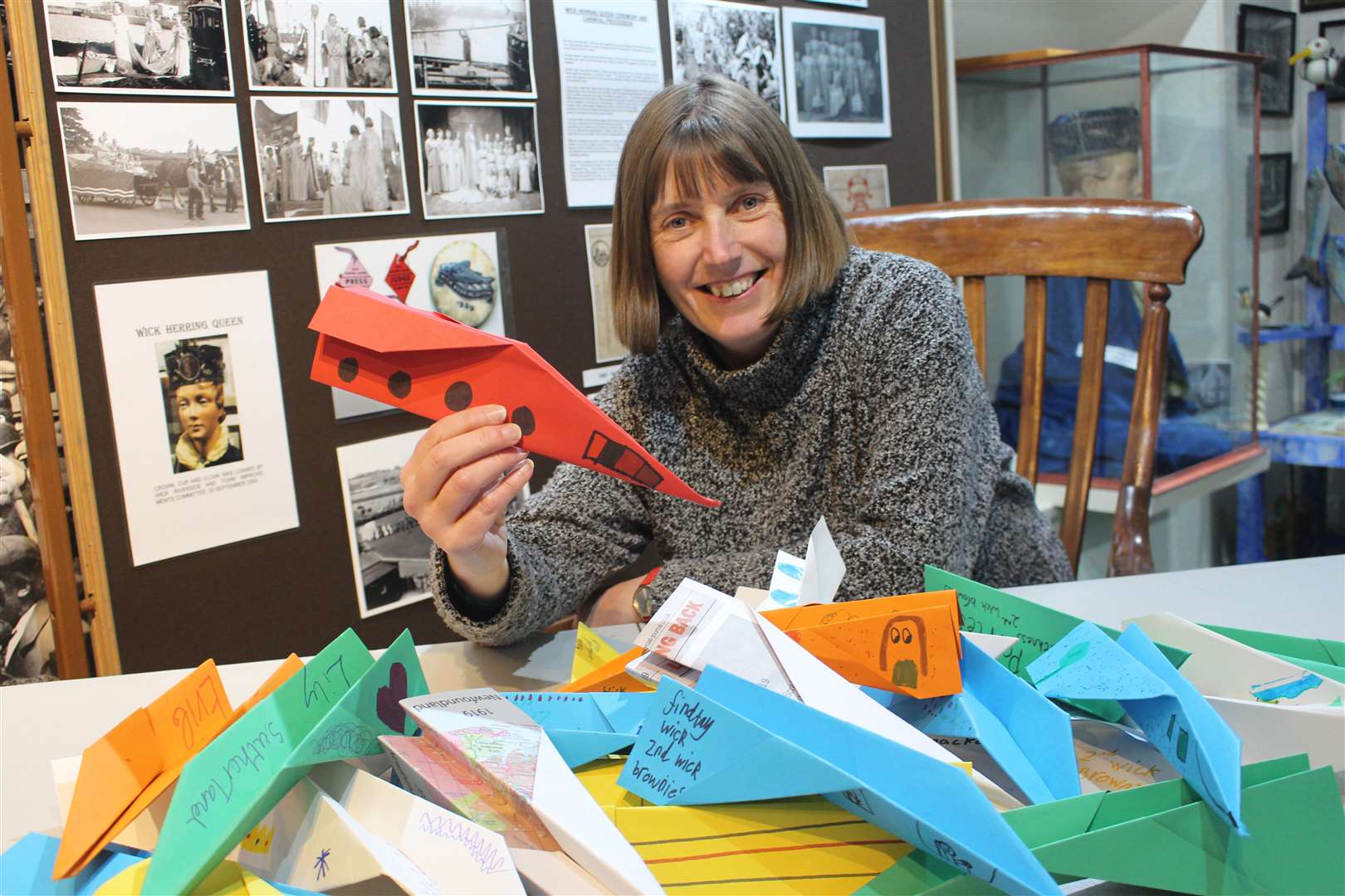 Artist Joanne B Kaar with some of the paper planes created by the 2nd Wick Brownies.