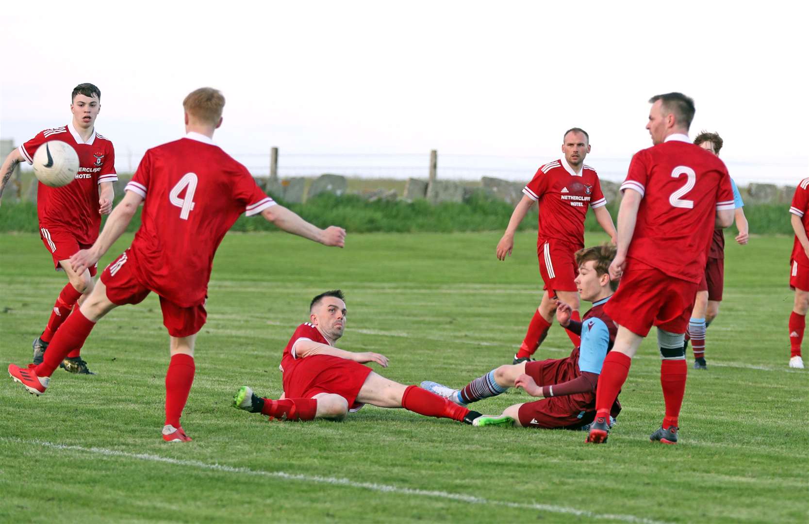 Andrew Brims pulls a goal back for Pentland United despite being surrounded by Wick Groats players. Picture: James Gunn