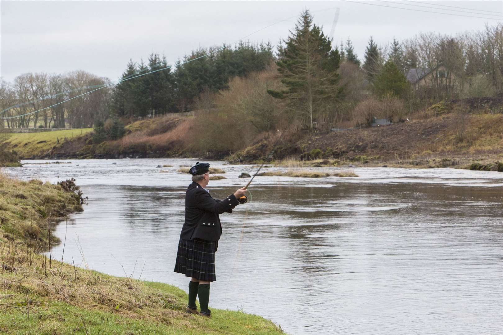 Official duties done after casting the first fly of the season, John Graham had a few casts further along the riverbank. Picture: Robert MacDonald / Northern Studios