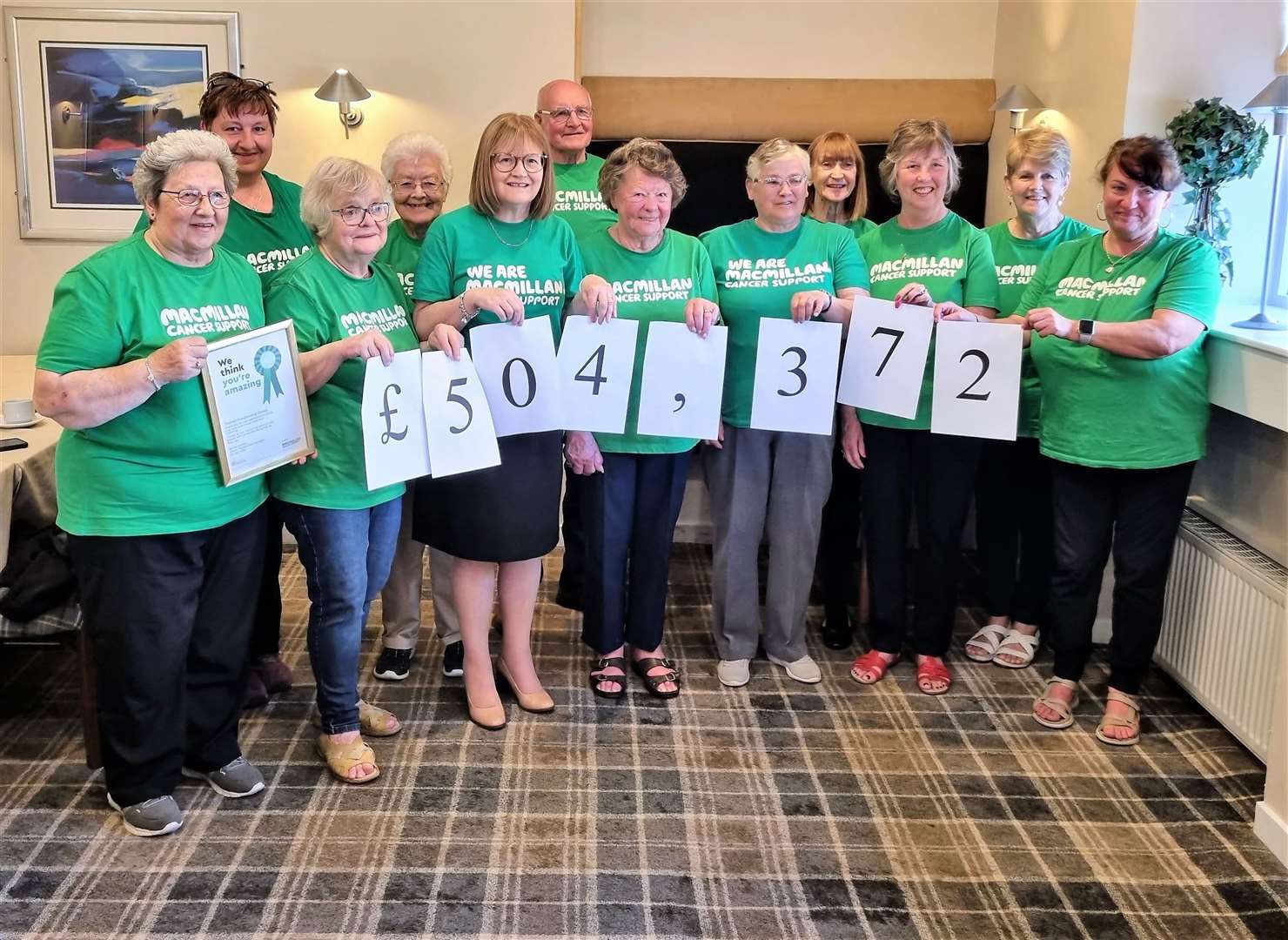 Members of the Macmillan Cancer Support Thurso Fundraising Group at the Pentland Hotel. The members hold up figures to represent the £504,372 raised over the years.