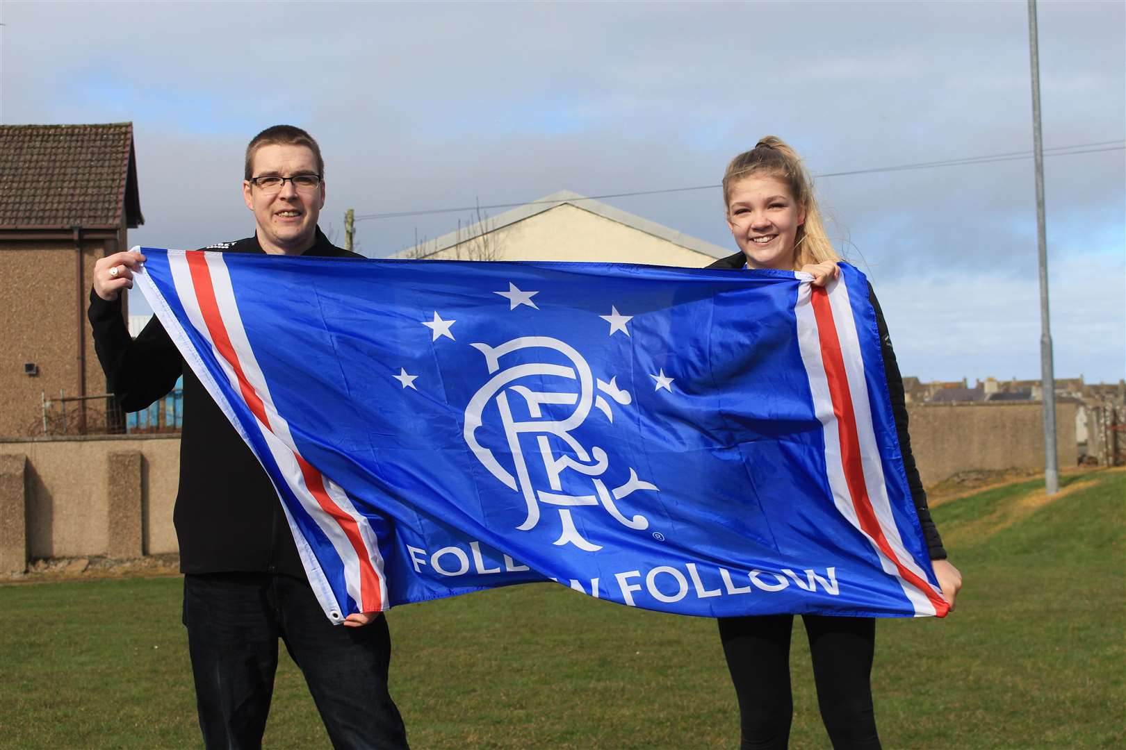 Alyn Gunn and his daughter Keira displaying their Rangers flag.