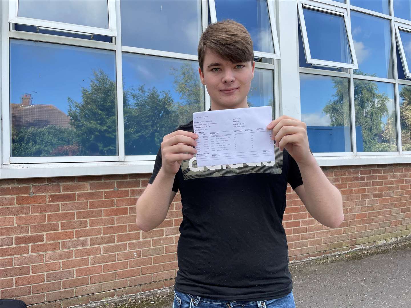 Dylan McAdam with his GCSE results (Jonathan McCambridge/PA)