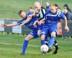 Cove players put the squeeze on Academy’s Gary Weir.