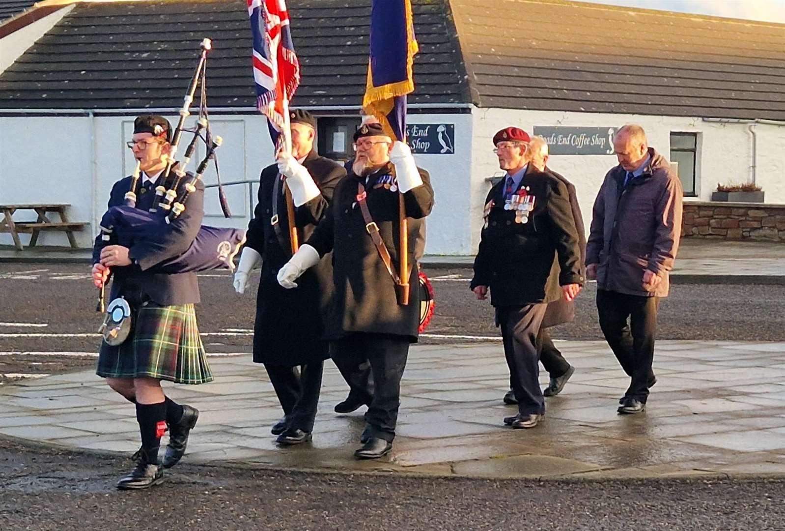 Piper Lewis MacLeod led a small group from the roundabout to the John O'Groats signpost.